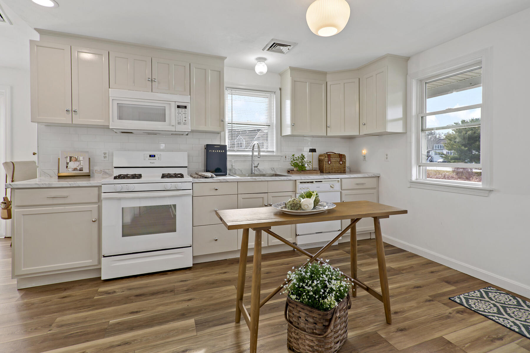 20 Evergreen Street Onset, MA 02558 - Photo 6 of 26 a kitchen with a stove a white cabinets and wooden floor