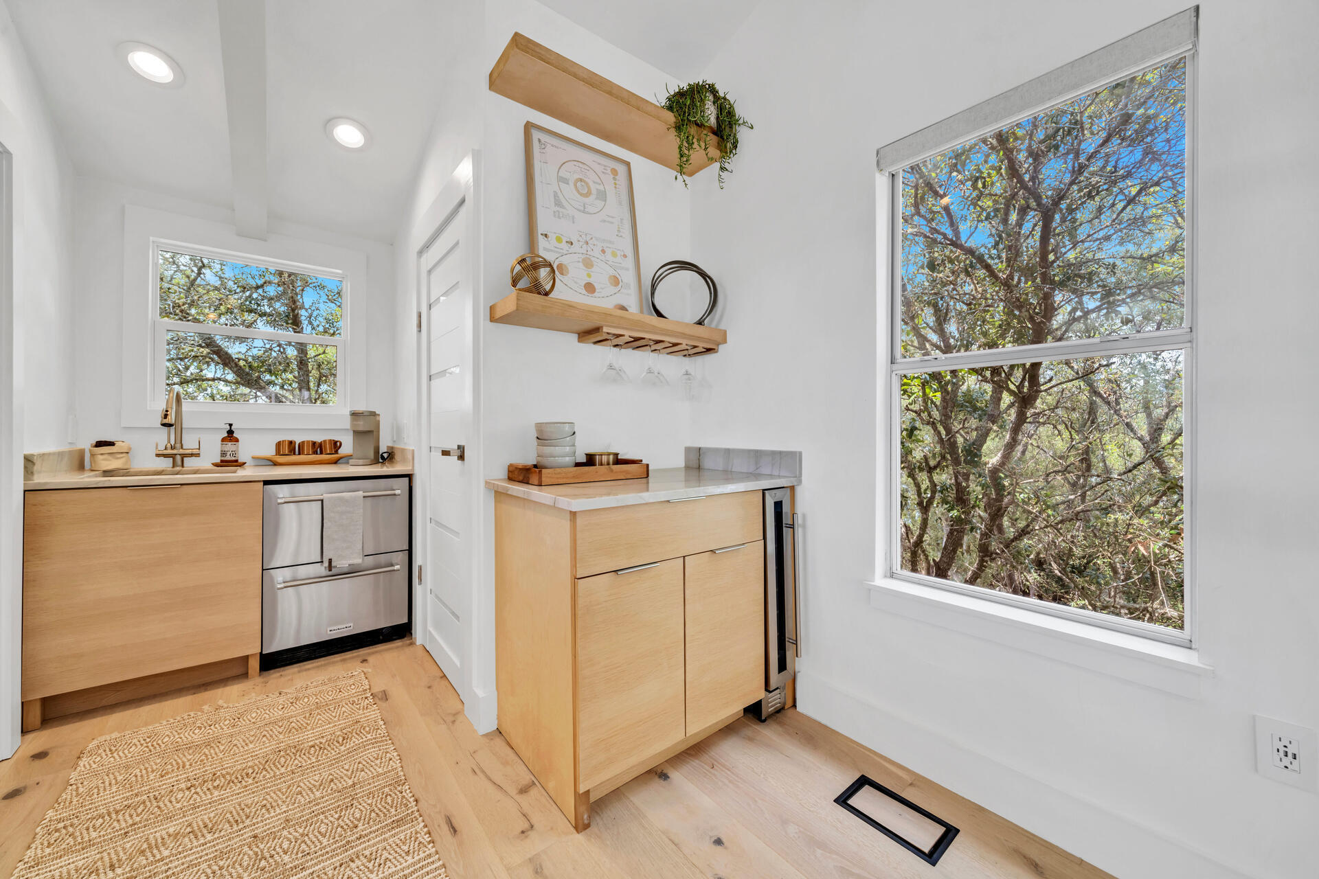 6296 West County Highway 30A Santa Rosa Beach, FL 32459 - Photo 11 of 121 a kitchen with white cabinets and white appliances