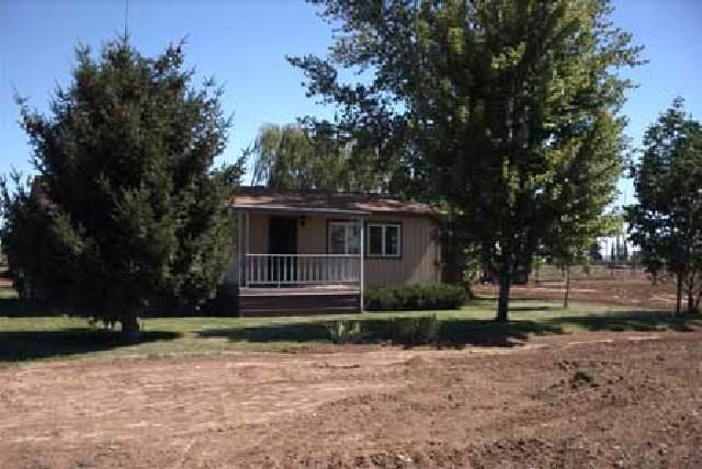 5131 Lateral A Road Wapato, WA 98951 - Photo 1 of 7 a front view of a house with a yard