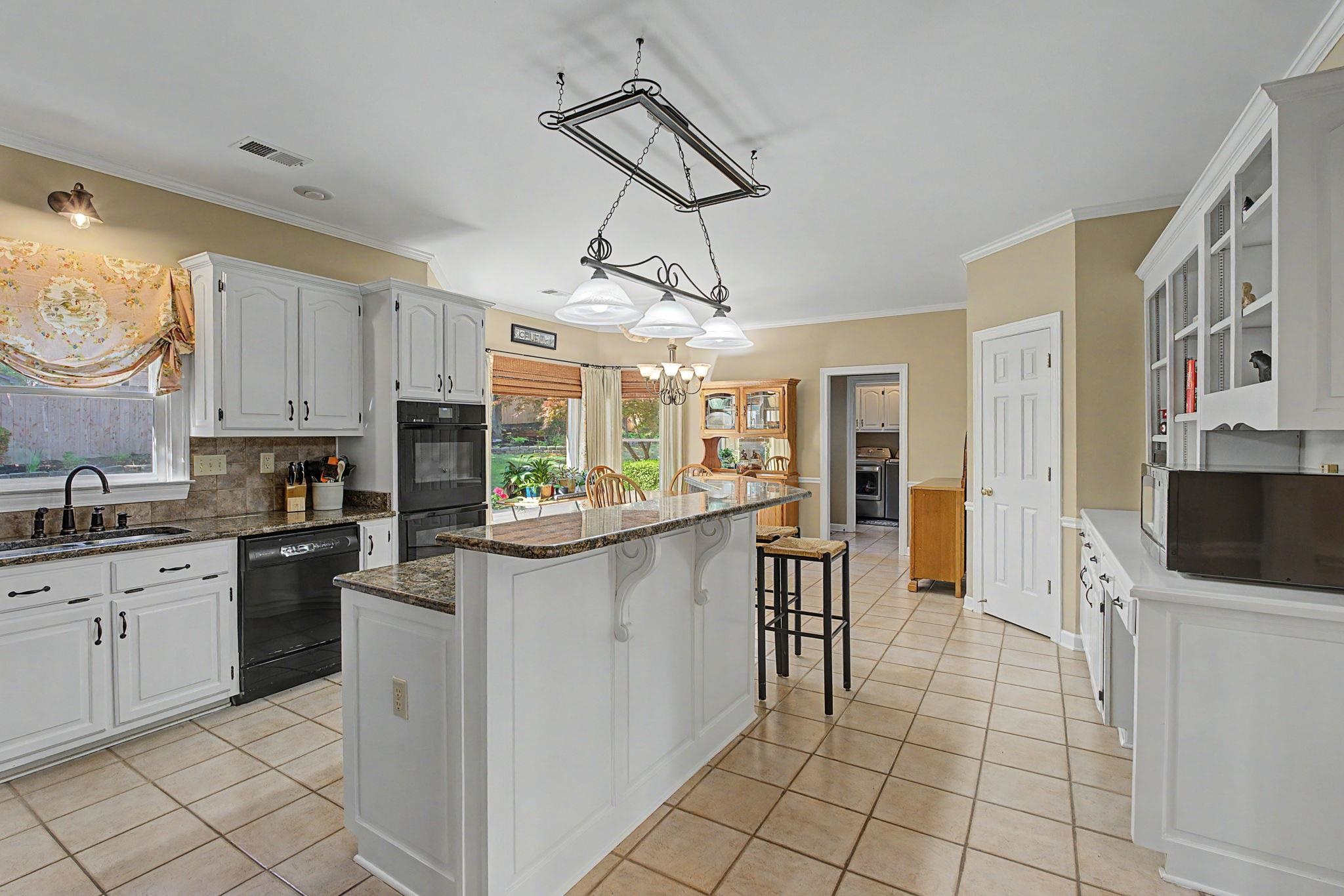 337 Revell Cove Collierville, TN 38017 - Photo 11 of 40 a kitchen with stainless steel appliances a stove refrigerator sink and cabinets