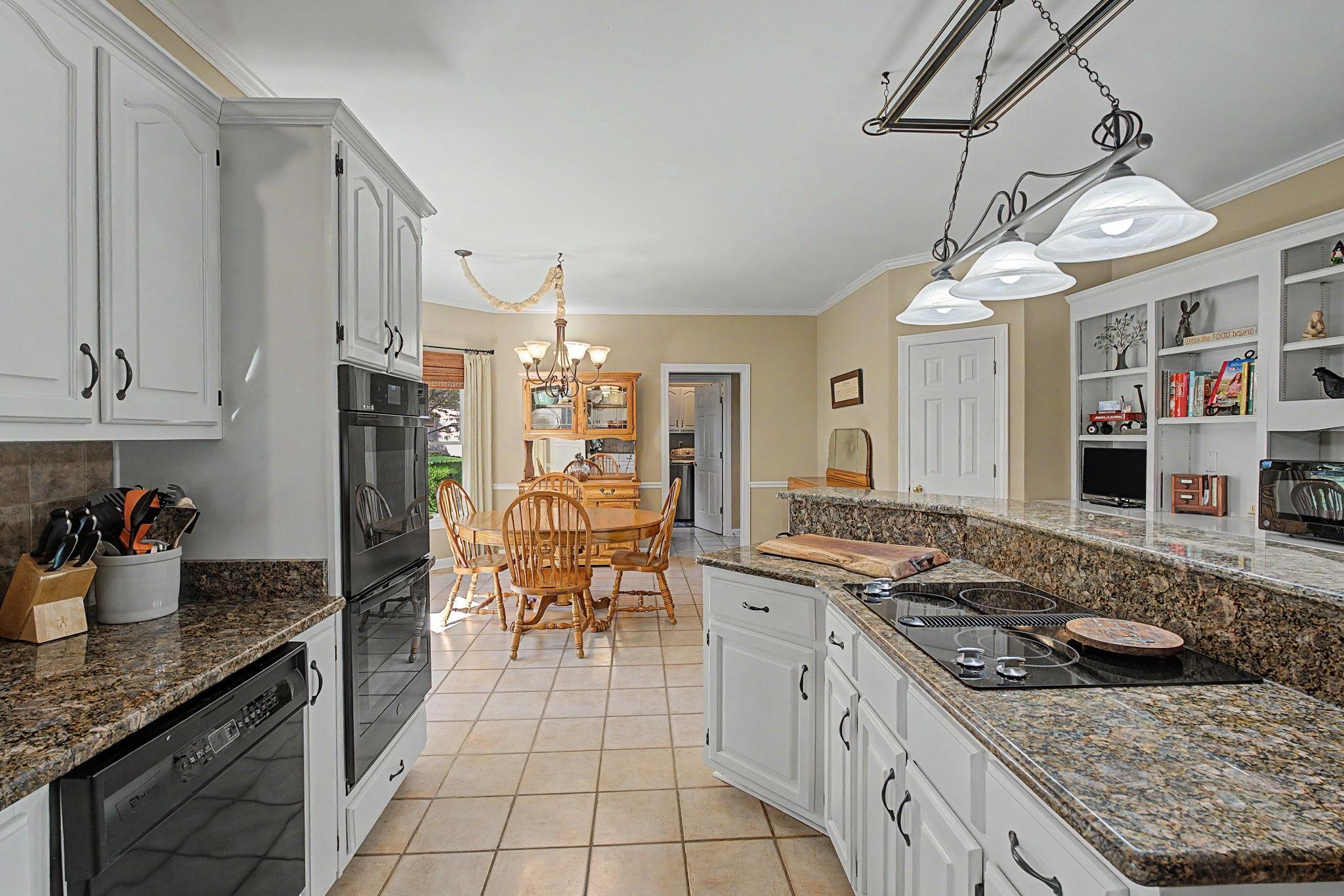 337 Revell Cove Collierville, TN 38017 - Photo 15 of 40 a kitchen with stainless steel appliances granite countertop a stove a sink and a refrigerator