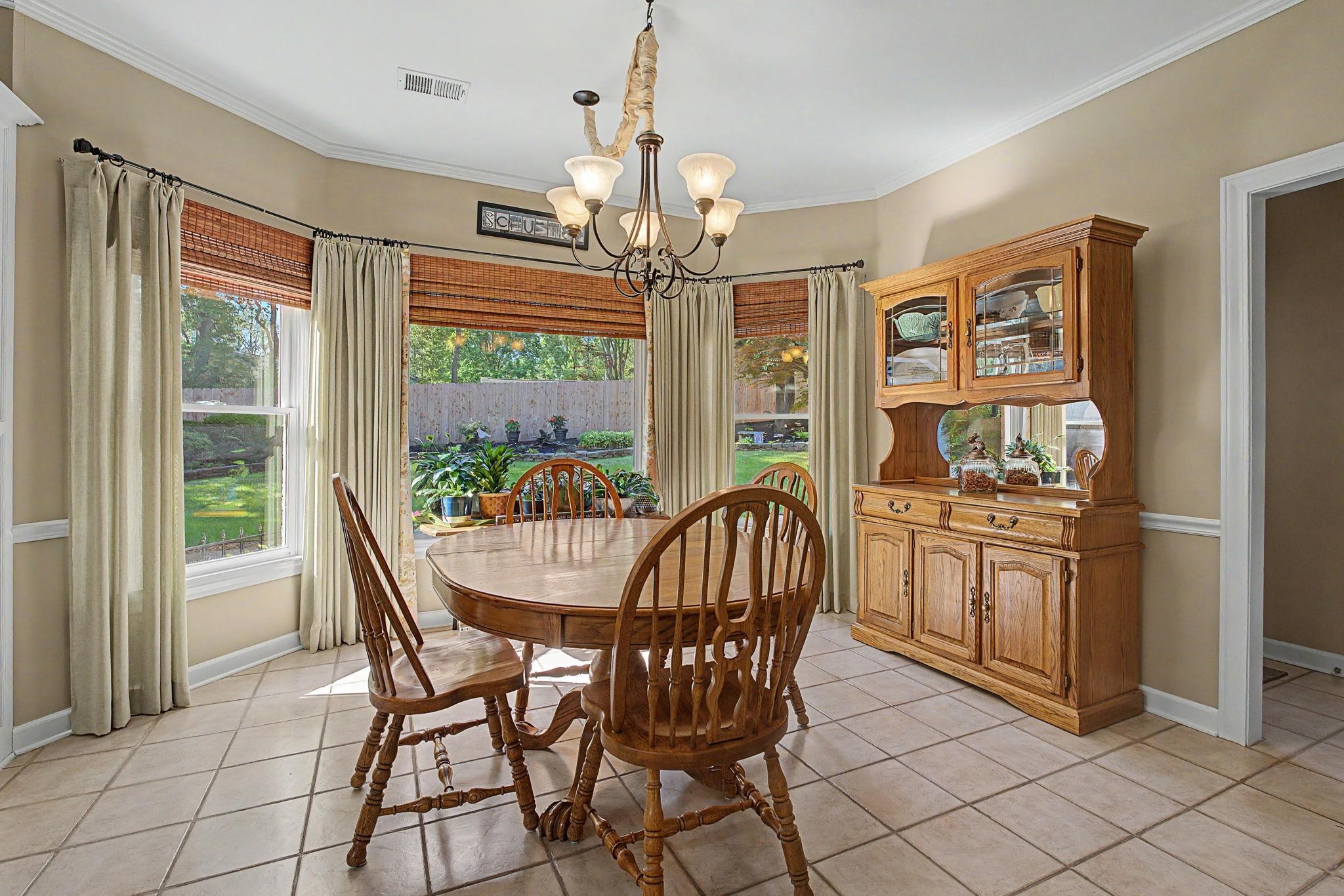 337 Revell Cove Collierville, TN 38017 - Photo 16 of 40 a view of a dining room with furniture large windows and wooden floor