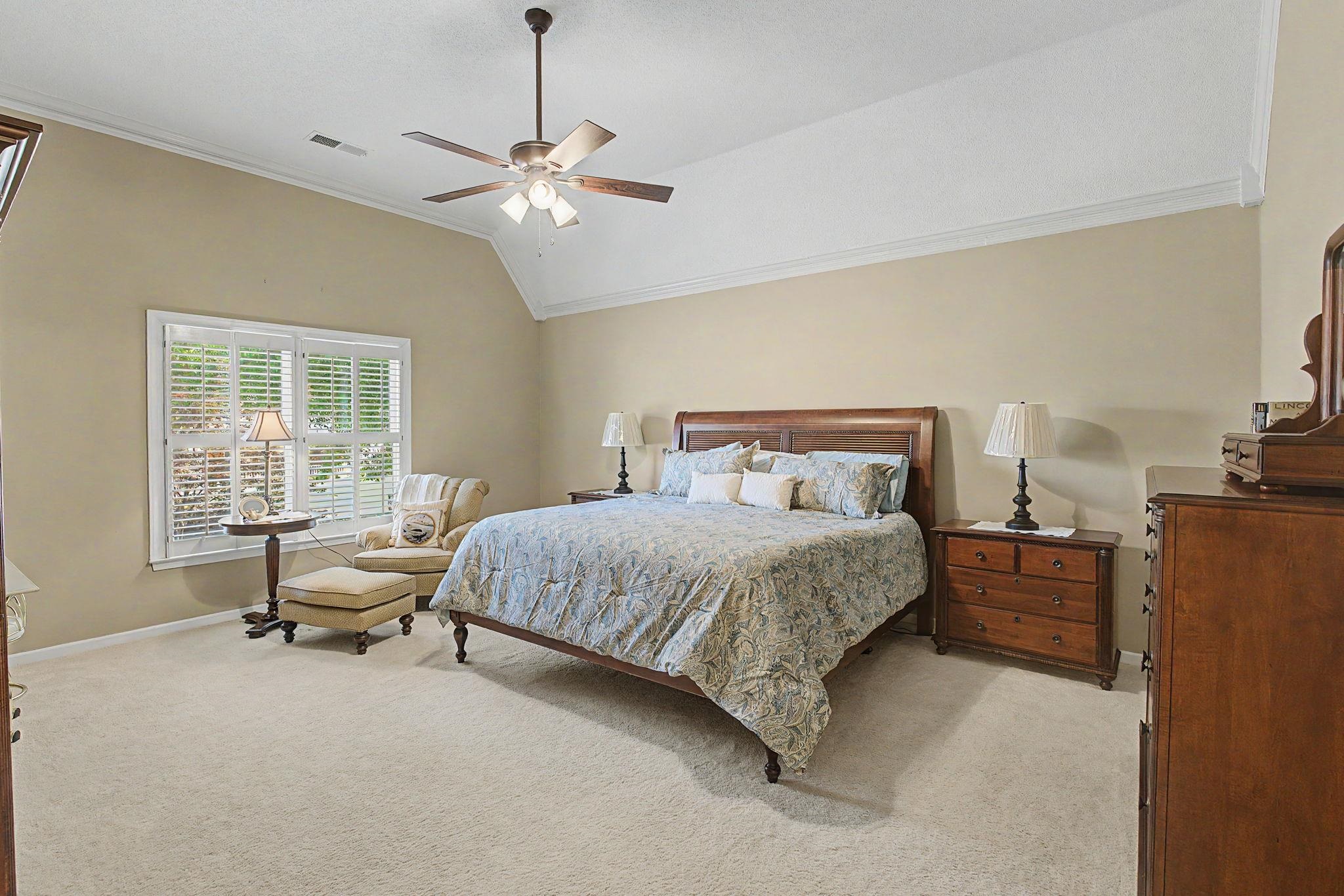 337 Revell Cove Collierville, TN 38017 - Photo 20 of 40 a bedroom with a bed and a chandelier