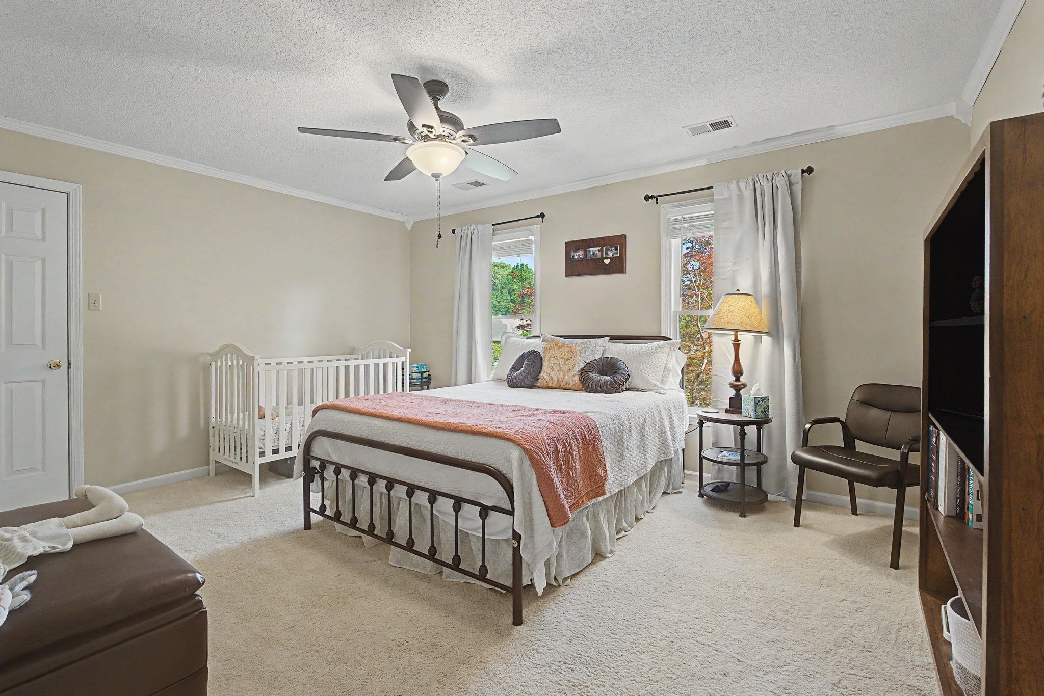 337 Revell Cove Collierville, TN 38017 - Photo 26 of 40 a bedroom with a bed and a chandelier