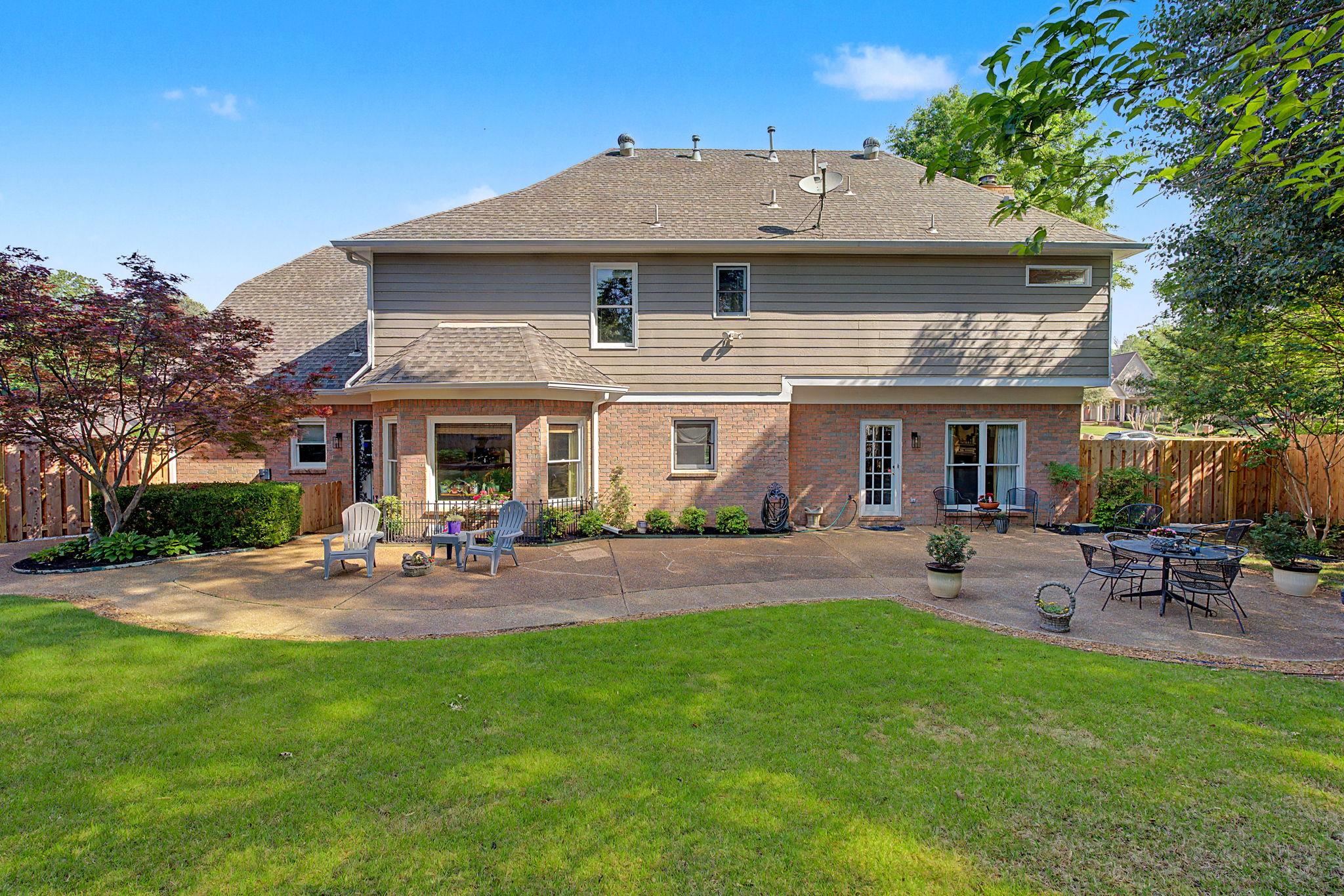 337 Revell Cove Collierville, TN 38017 - Photo 35 of 40 a front view of a house with a garden and patio