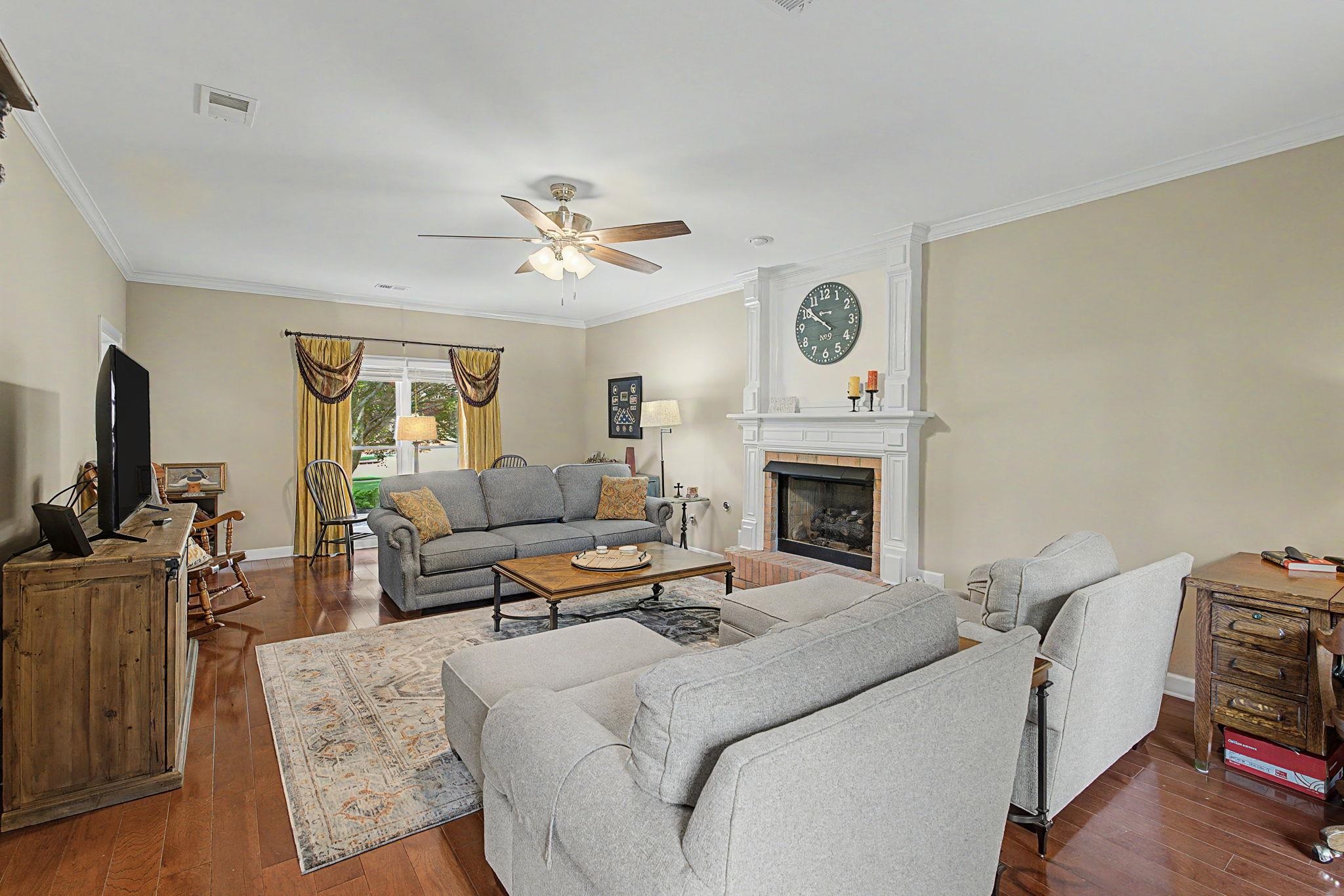 337 Revell Cove Collierville, TN 38017 - Photo 10 of 40 a living room with furniture a flat screen tv and a fireplace