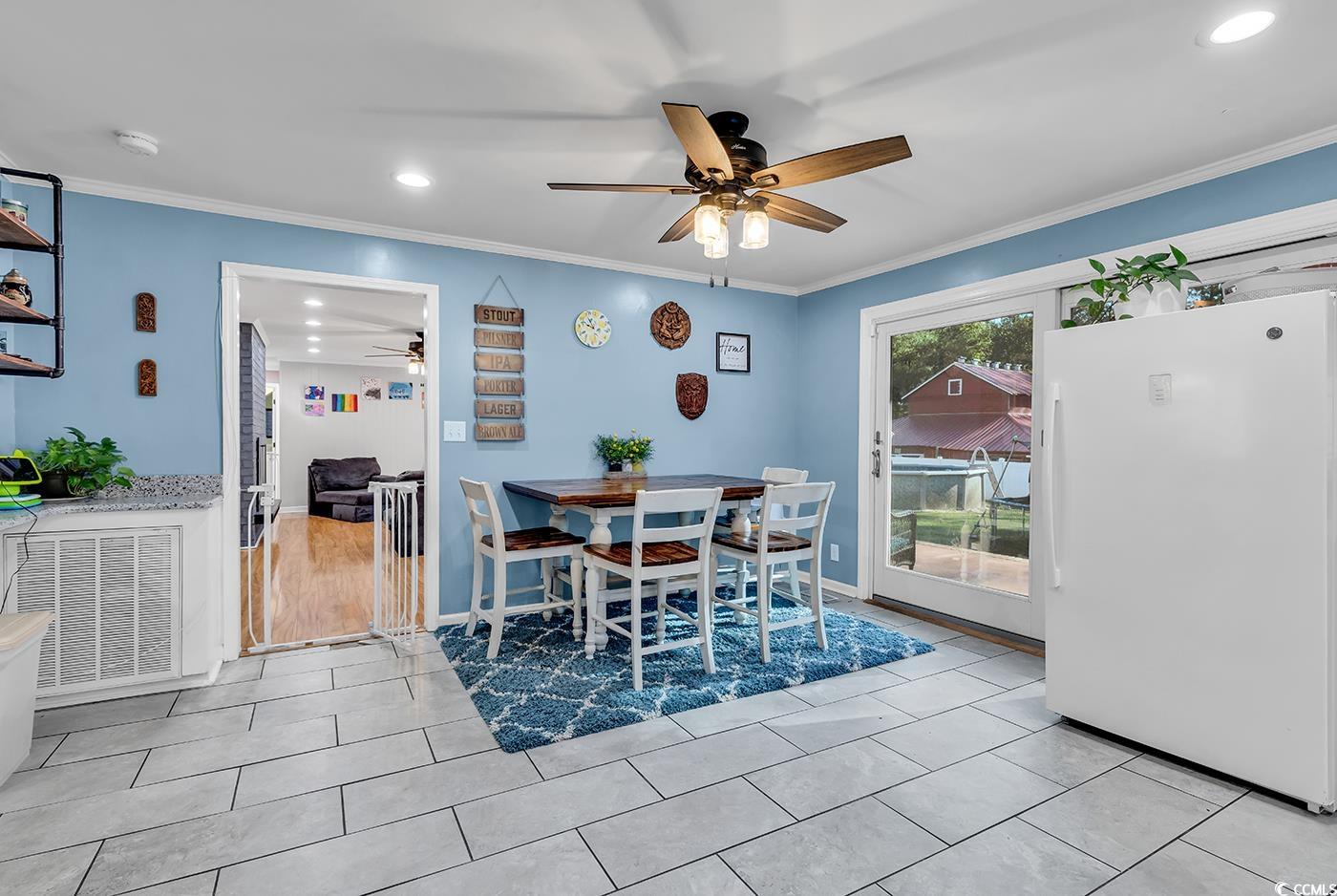374 North Cox Road Loris, SC 29569 - Photo 13 of 40 Tiled dining area with ceiling fan and crown moldi