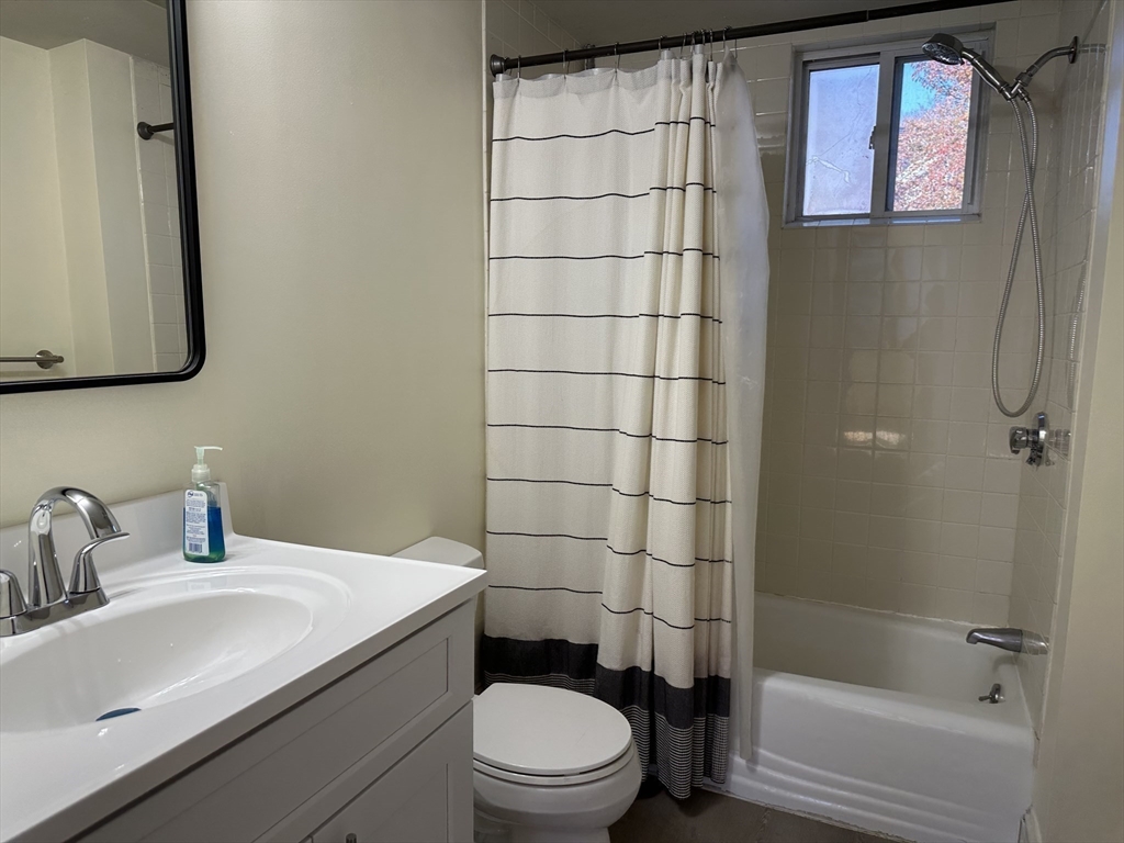 90 Russell Street, Unit 90 Melrose, MA 02176 - Photo 8 of 9 a bathroom with a sink toilet and shower