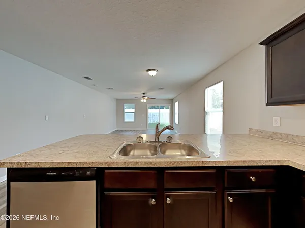 a kitchen with granite countertop a sink and cabinets