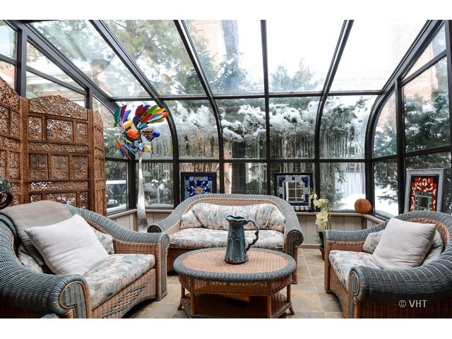 15 Landmark Street Northfield, IL 60093 - Photo 16 of 22 a living room with furniture a fireplace and a floor to ceiling window