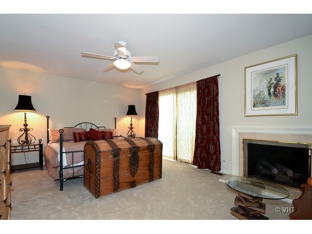 15 Landmark Street Northfield, IL 60093 - Photo 10 of 22 a living room with furniture a fireplace and a chandelier