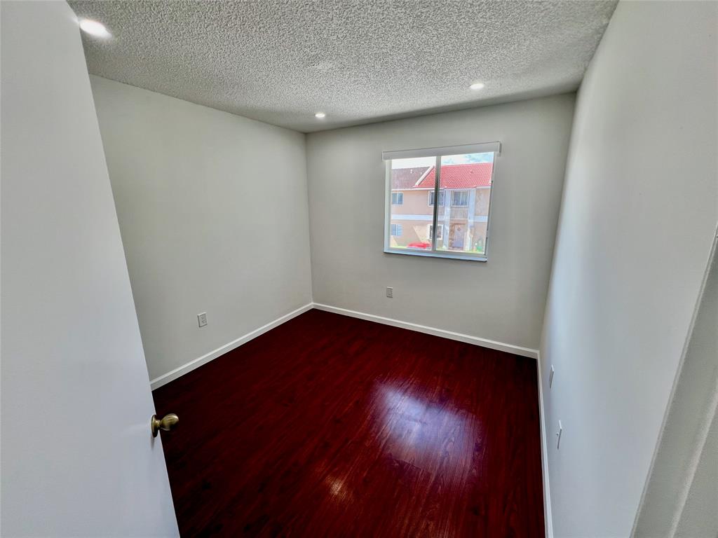 14156 Southwest 179th Terrace Miami, FL 33177 - Photo 23 of 37 an empty room with wooden floor and windows
