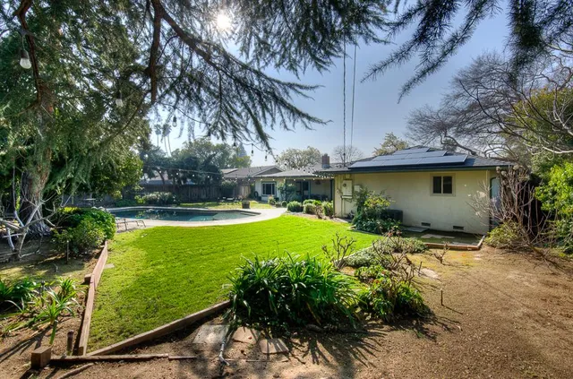 a view of a backyard with plants and a patio