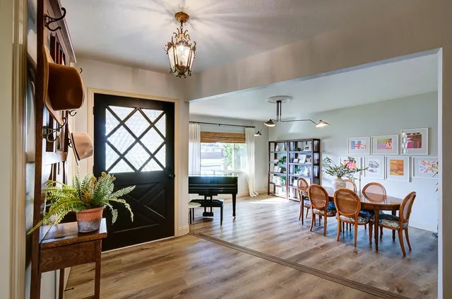 a view of a dining room with furniture and wooden floor
