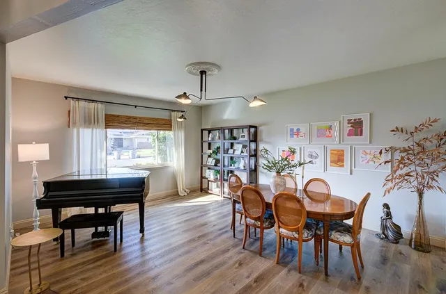 a view of a dining room with furniture and wooden floor