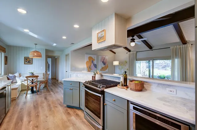 a kitchen with stainless steel appliances granite countertop a stove and a sink