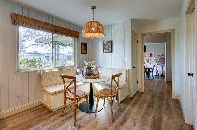 a view of a dining room with furniture window and wooden floor