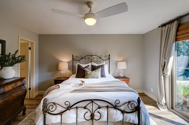 a bedroom with a bed and a chandelier