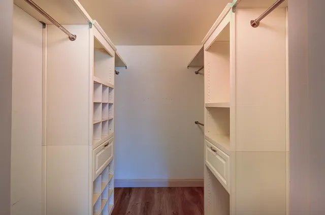 a view of a hallway with wooden floor and entryway
