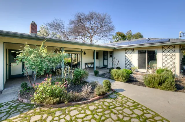 a front view of a house with garden