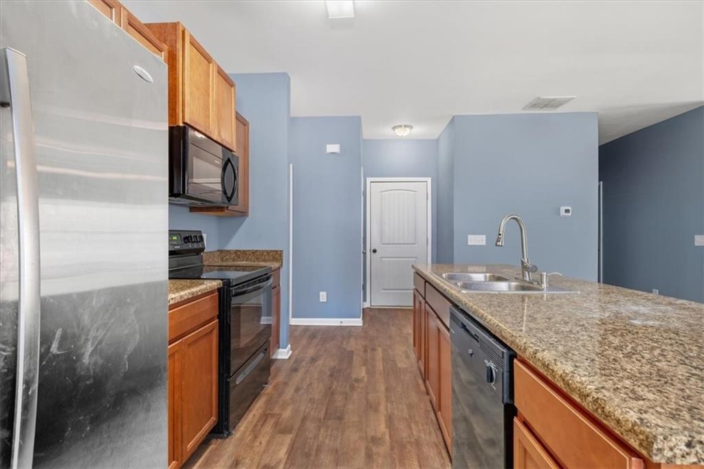 15 Grandberry Court Rome, GA 30165 - Photo 13 of 23 a kitchen with stainless steel appliances granite countertop a sink stove and refrigerator