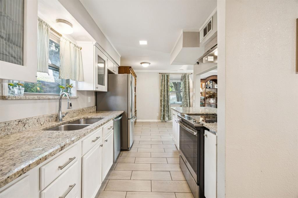 3284 Golfing Green Drive Farmers Branch, TX 75234 - Photo 11 of 25 a kitchen with granite countertop a sink stove and refrigerator