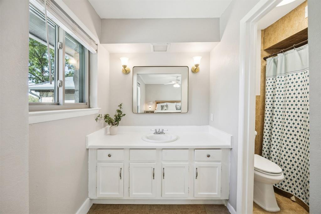 3284 Golfing Green Drive Farmers Branch, TX 75234 - Photo 16 of 25 a bathroom with a sink vanity granite toilet and a mirror