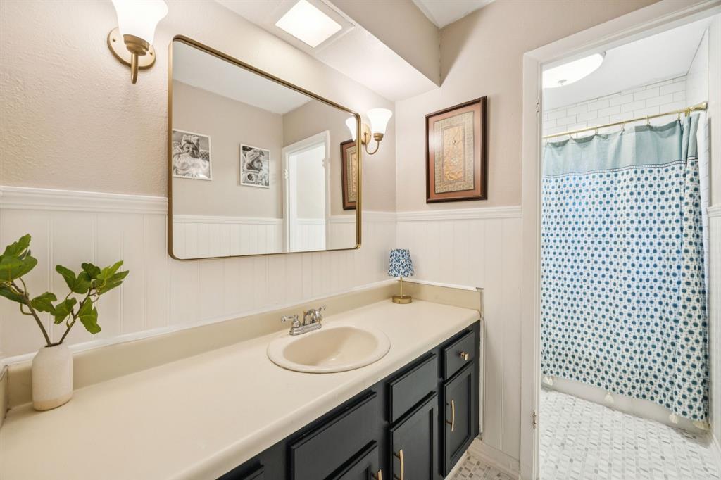 3284 Golfing Green Drive Farmers Branch, TX 75234 - Photo 19 of 25 a bathroom with a sink and a mirror