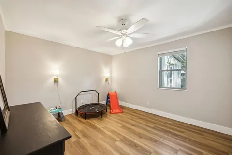 a view of a room with wooden floor and window