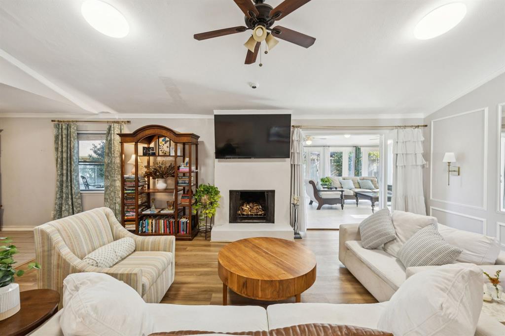 3284 Golfing Green Drive Farmers Branch, TX 75234 - Photo 2 of 25 a living room with furniture a fireplace and a flat screen tv