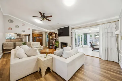 a living room with fireplace furniture and a wooden floor