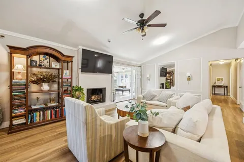 a living room with furniture a fireplace and a flat screen tv