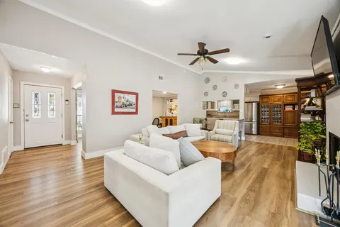 a living room with furniture and a wooden floor