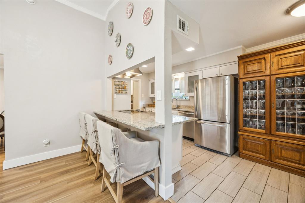 3284 Golfing Green Drive Farmers Branch, TX 75234 - Photo 8 of 25 a kitchen with granite countertop a refrigerator and a stove top oven