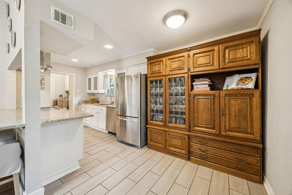 3284 Golfing Green Drive Farmers Branch, TX 75234 - Photo 10 of 25 a kitchen with stainless steel appliances granite countertop a refrigerator and cabinets