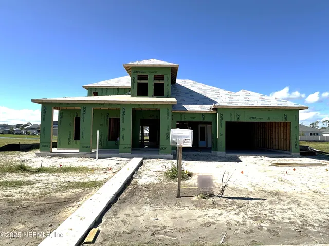 a view of a house with large windows and a fireplace