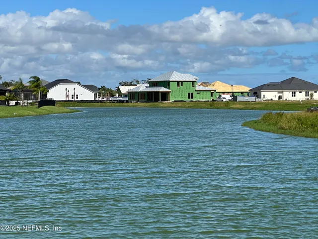a view of a kitchen with stainless steel appliances wooden floor and a counter top space