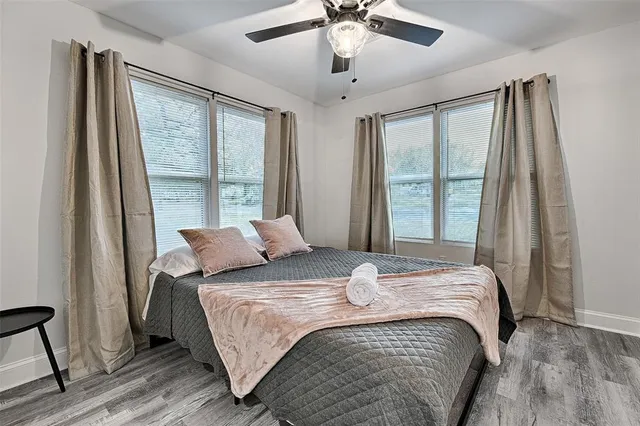 a bedroom with a bed and a large window