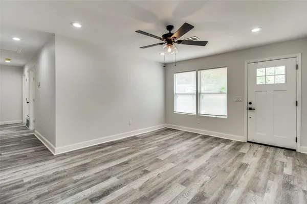 wooden floor in an empty room with a window