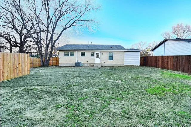 a backyard of a house with table and chairs