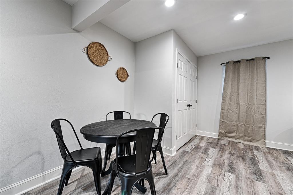 1201 Ridgewood Road Denison, TX 75020 - Photo 3 of 29 a view of a dining room and kitchen with a table chairs and wooden floor