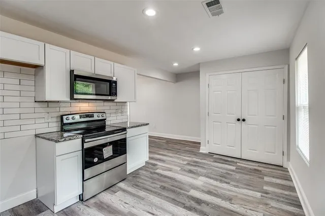 a view of kitchen with sink and stainless steel appliances