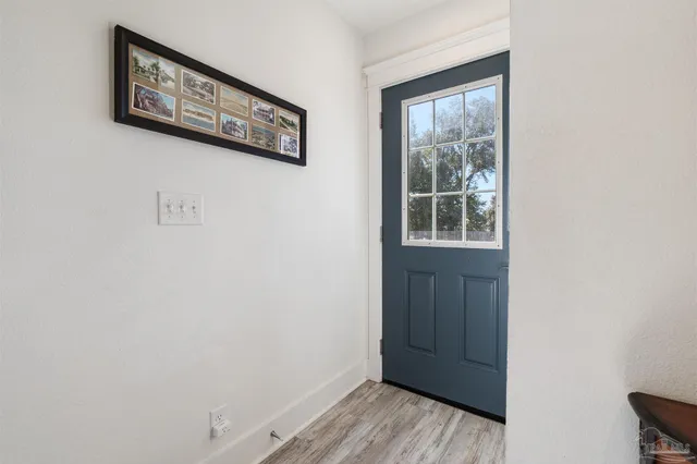 a view of staircase with wooden floor and windows