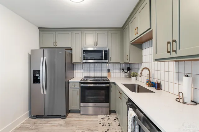 a kitchen with granite countertop a stove sink and cabinets