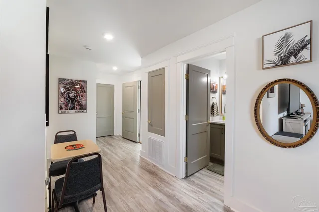 a bathroom with a granite countertop sink a toilet and a mirror