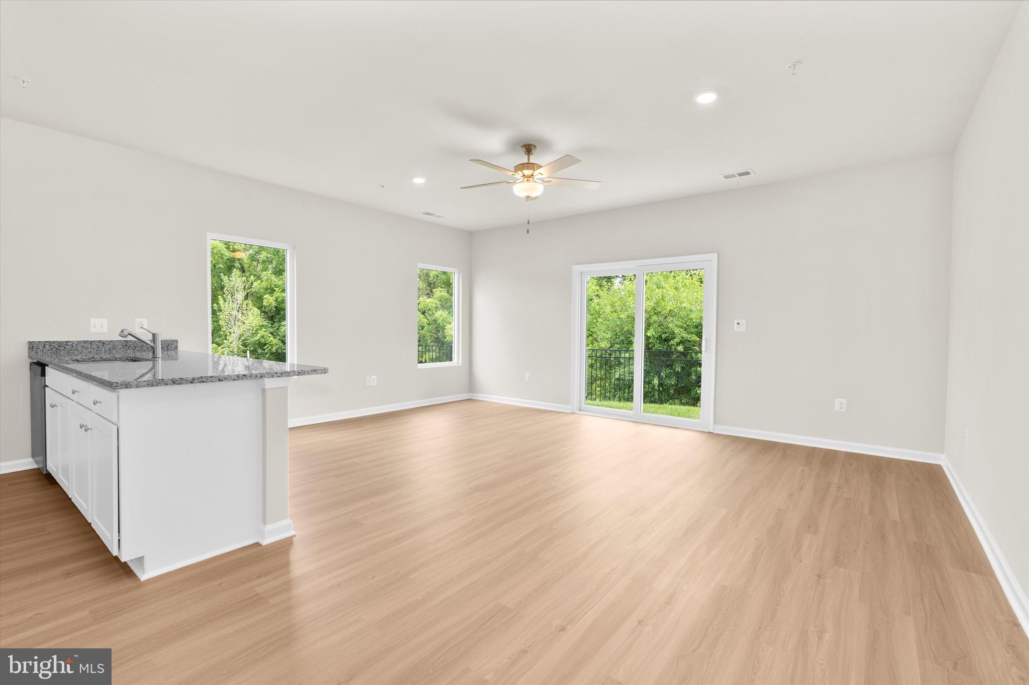 8135 Bartholomew Court Baltimore, MD 21206 - Photo 20 of 46 a view of an empty room with window and wooden floor