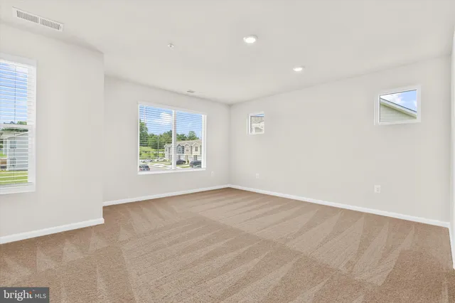 a view of a small space with wooden floor and a window