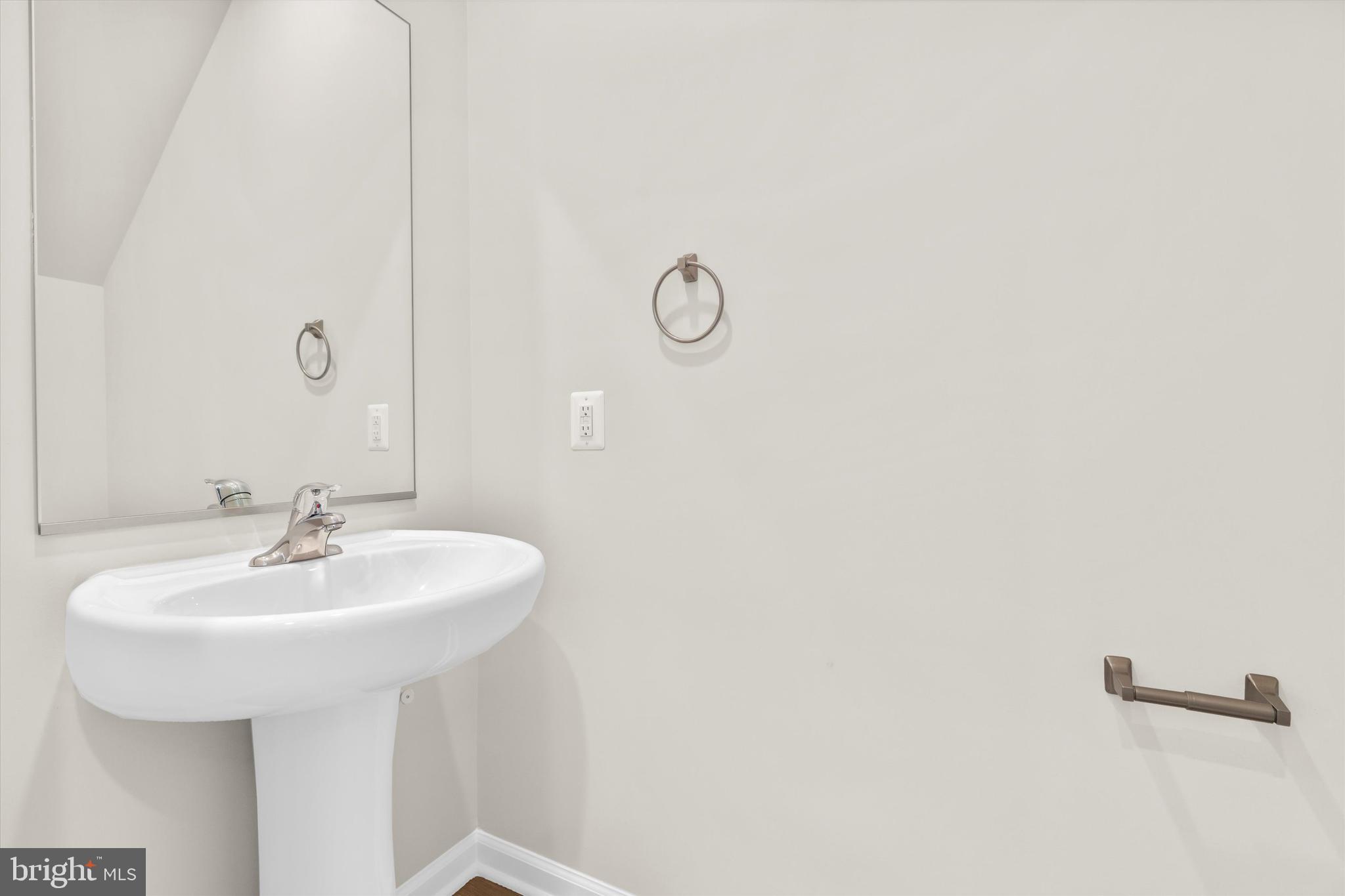 8135 Bartholomew Court Baltimore, MD 21206 - Photo 43 of 46 a bathroom with a sink a mirror and a shower