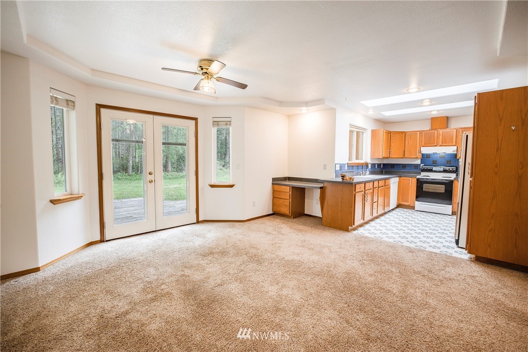 20 East Rd Of Tralee Shelton, WA 98584 - Photo 7 of 18 a view of a livingroom with furniture cabinet a ceiling fan and windows