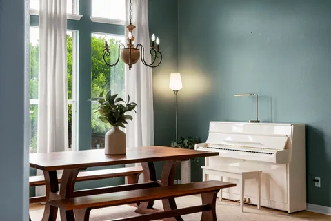 a view of a workspace with furniture and a window